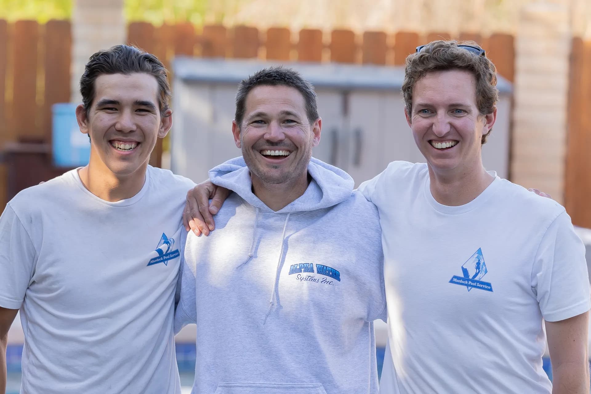 Brett Murdock with two team members in front of pool equipment, ready to diagnose and repair